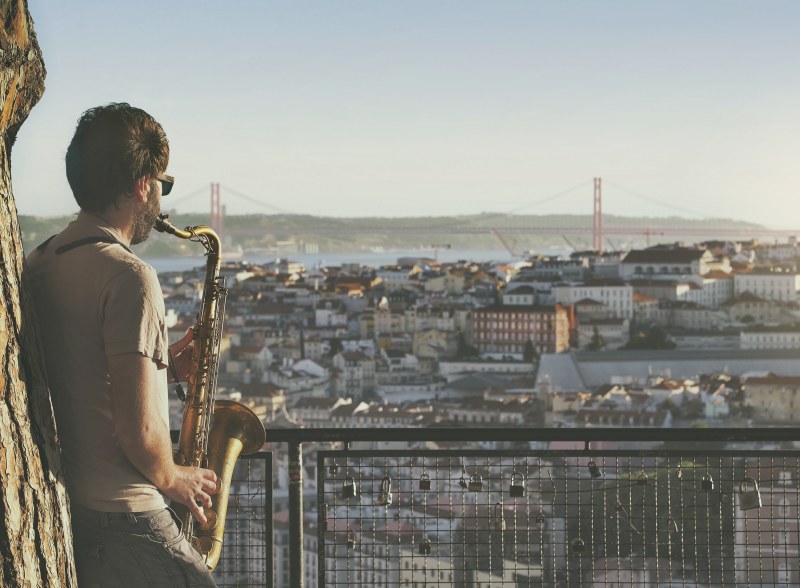 Mann spielt Saxophon über Lissabon