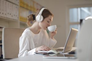 Eine Frau benutzt Bluetooth-Kopfhörer zum Arbeiten