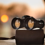 Fernglas liegt auf einer Schachtel